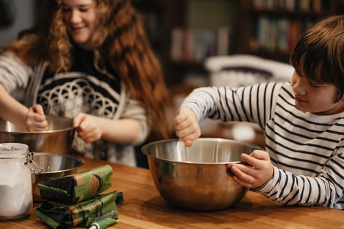 kids in a kitchen stirring a bowl